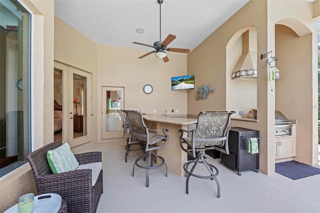 view of patio featuring ceiling fan and exterior bar