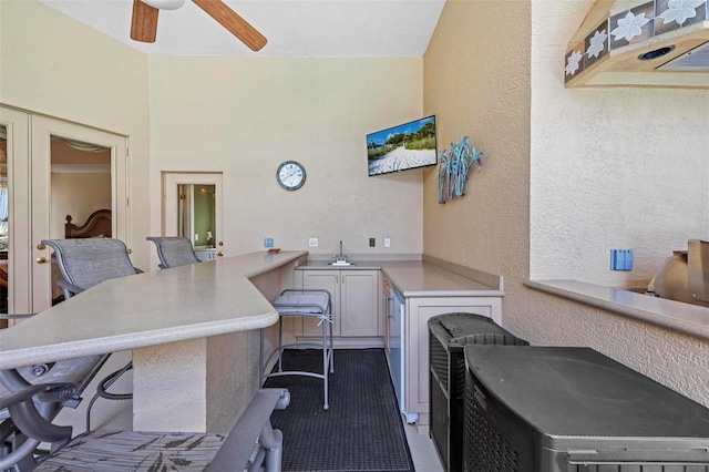 interior space with ceiling fan and sink