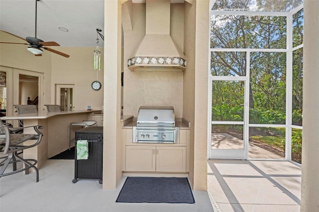 exterior space with a kitchen breakfast bar, ceiling fan, plenty of natural light, and custom exhaust hood