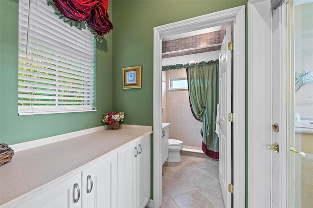 bathroom featuring tile patterned flooring, vanity, and toilet