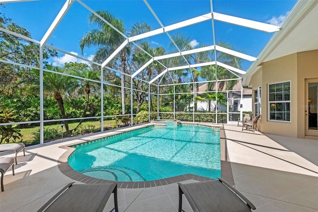 view of pool with a patio and glass enclosure