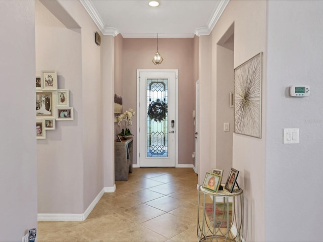 foyer with crown molding and light tile patterned floors