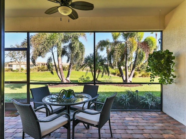 sunroom / solarium featuring ceiling fan