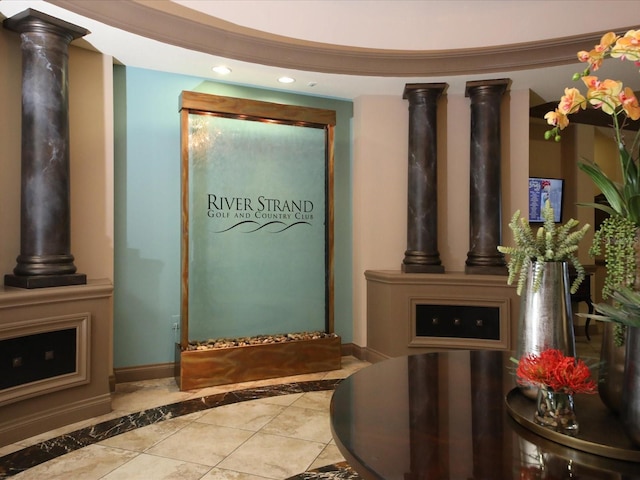 interior space featuring crown molding and light tile patterned floors