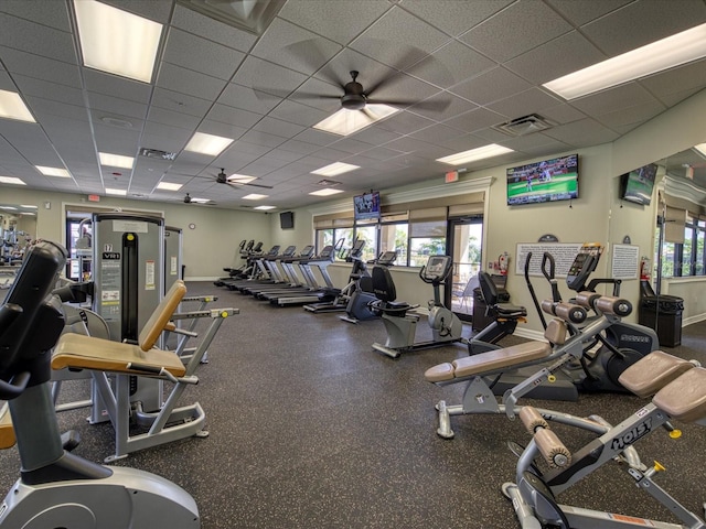 exercise room with a paneled ceiling and ceiling fan