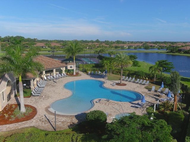 view of pool featuring a patio area and a water view