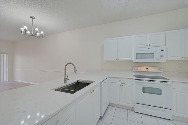 4210 Caddie Dr E Unit 102, Bradenton, FL 34203 - kitchen featuring a sink, a textured ceiling, white cabinetry, white appliances, and light countertops
