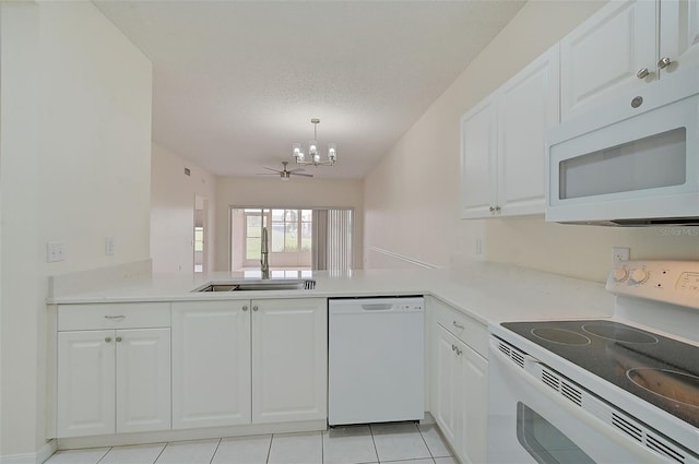 kitchen featuring sink, a notable chandelier, white cabinets, a textured ceiling, and white appliances