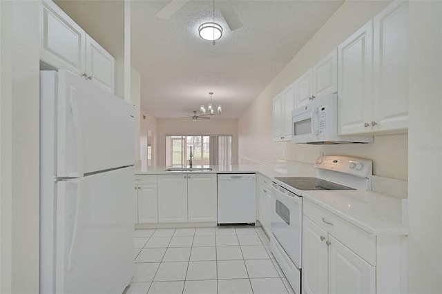 kitchen featuring sink, white cabinetry, a textured ceiling, and white appliances