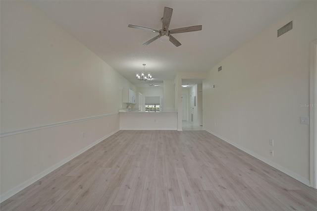 4210 Caddie Dr E Unit 102, Bradenton, FL 34203 - unfurnished living room with baseboards, light wood-style flooring, visible vents, and ceiling fan with notable chandelier