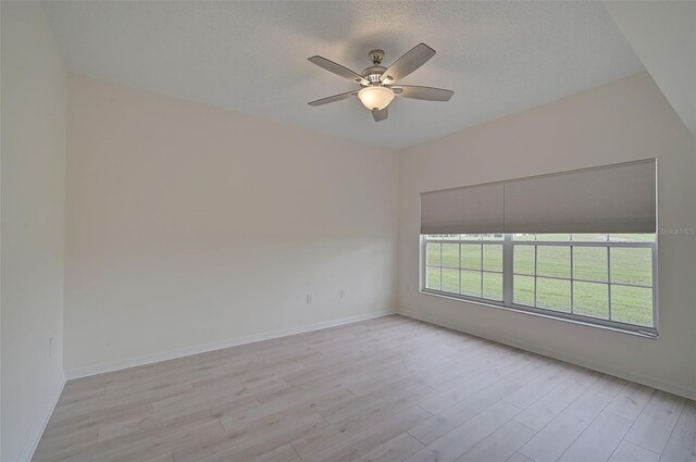 4210 Caddie Dr E Unit 102, Bradenton, FL 34203 - empty room featuring baseboards, light wood finished floors, ceiling fan, and a textured ceiling