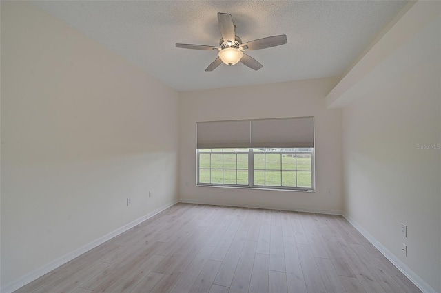 4210 Caddie Dr E Unit 102, Bradenton, FL 34203 - spare room featuring a textured ceiling, light wood-style flooring, baseboards, and ceiling fan