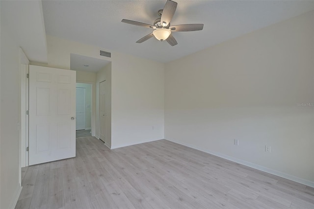 empty room with light wood-type flooring and ceiling fan