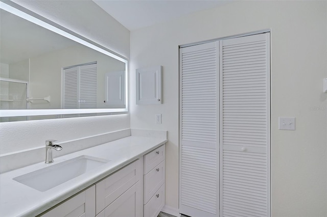 4210 Caddie Dr E Unit 102, Bradenton, FL 34203 - bathroom with a closet, a shower with door, and vanity