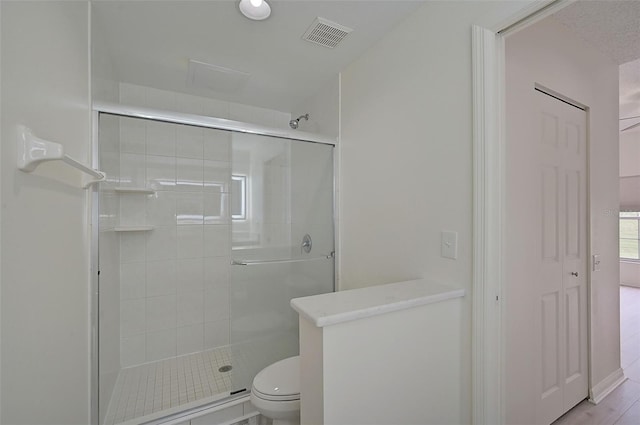4210 Caddie Dr E Unit 102, Bradenton, FL 34203 - bathroom featuring a stall shower, toilet, and visible vents