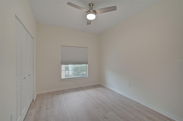 4210 Caddie Dr E Unit 102, Bradenton, FL 34203 - unfurnished bedroom with a closet, baseboards, light wood-style flooring, and a ceiling fan