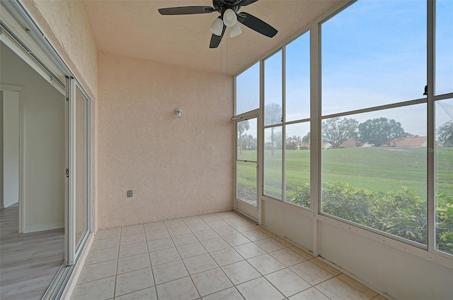 unfurnished sunroom featuring plenty of natural light and ceiling fan