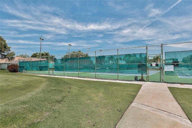 4210 Caddie Dr E Unit 102, Bradenton, FL 34203 - view of tennis court featuring a gate, fence, and a yard