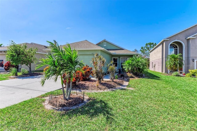 view of front of house with a garage and a front lawn