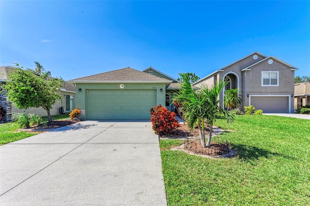 view of front of property with a front yard and a garage