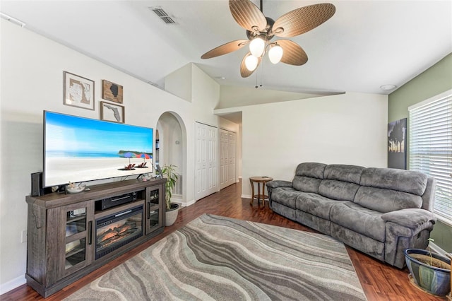 living room featuring vaulted ceiling, dark hardwood / wood-style floors, and ceiling fan