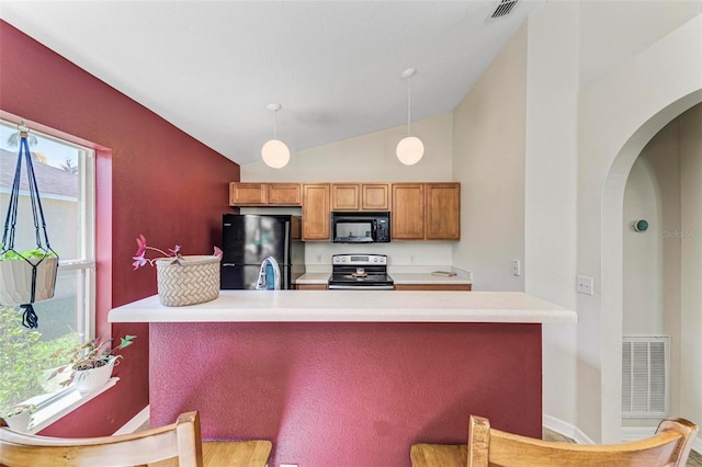 kitchen with sink, black appliances, lofted ceiling, and hanging light fixtures