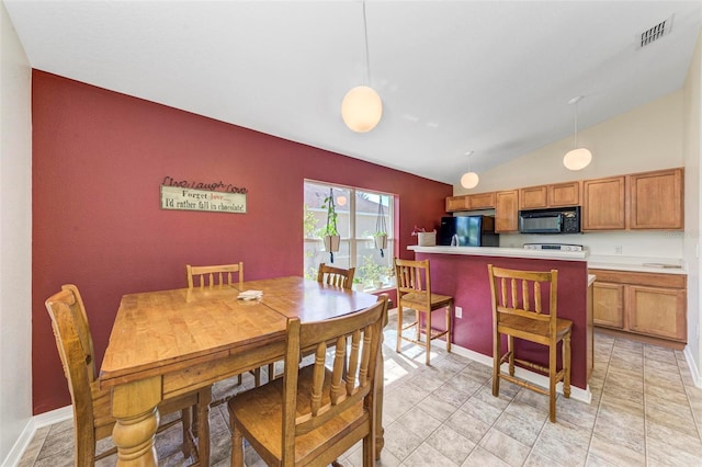 dining space with lofted ceiling