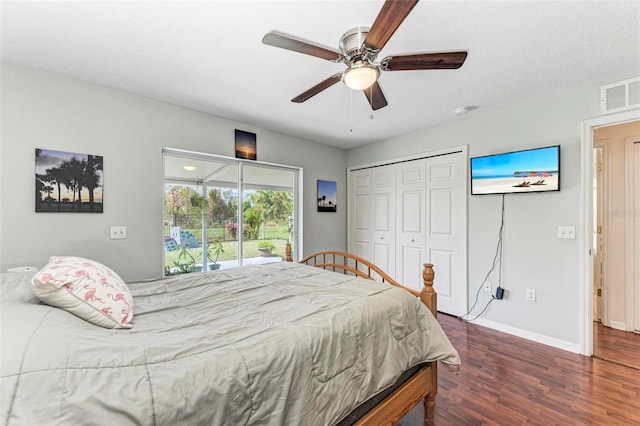 bedroom featuring access to outside, a textured ceiling, a closet, ceiling fan, and dark hardwood / wood-style floors