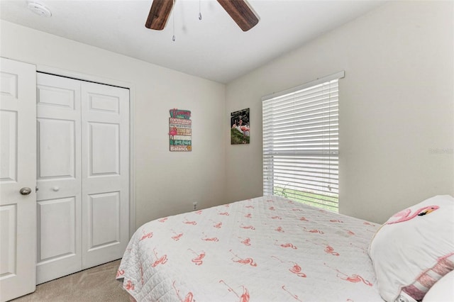 carpeted bedroom with a closet and ceiling fan