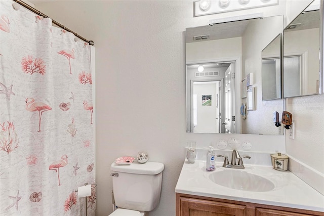 bathroom with toilet and vanity