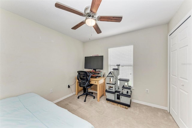 bedroom with a closet, light carpet, and ceiling fan