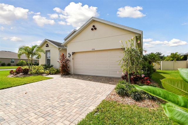 view of front facade with a garage and a front lawn