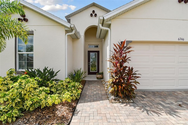 doorway to property with a garage