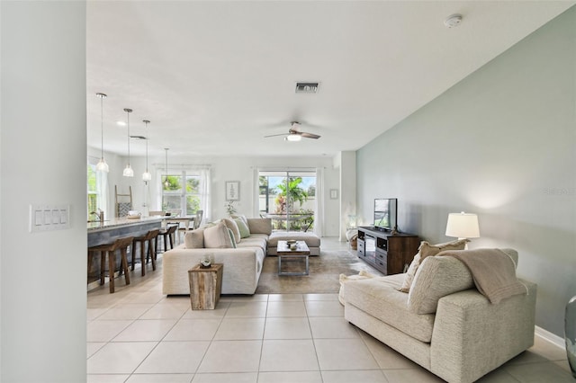 tiled living room featuring ceiling fan