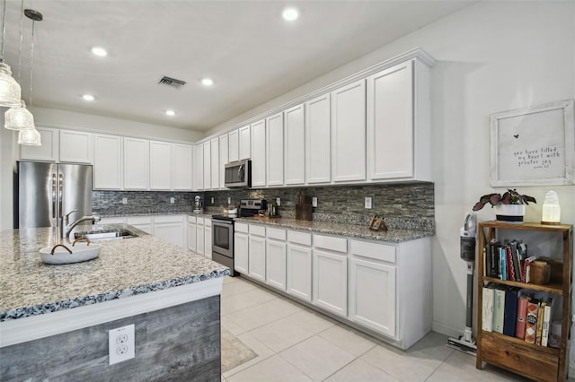 kitchen with pendant lighting, sink, white cabinetry, and stainless steel appliances