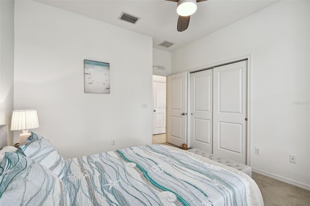 bedroom featuring light colored carpet, a closet, and ceiling fan