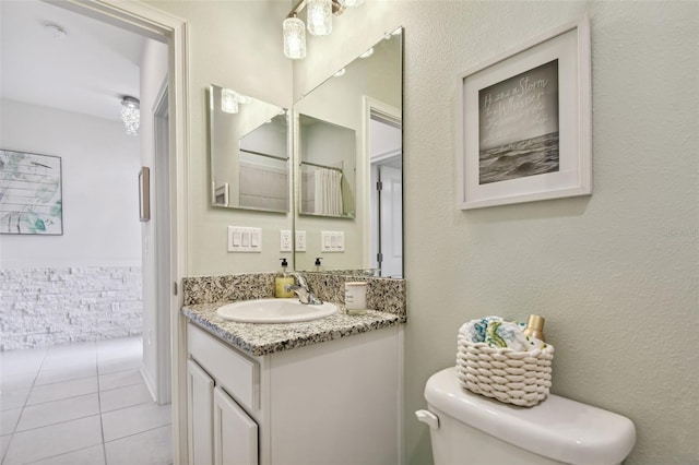 bathroom with vanity, toilet, and tile patterned flooring