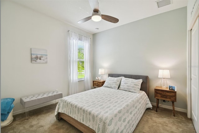 carpeted bedroom with a closet and ceiling fan