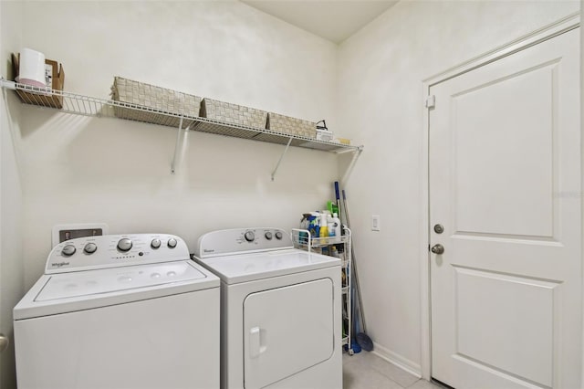 washroom featuring light tile patterned floors and washing machine and clothes dryer