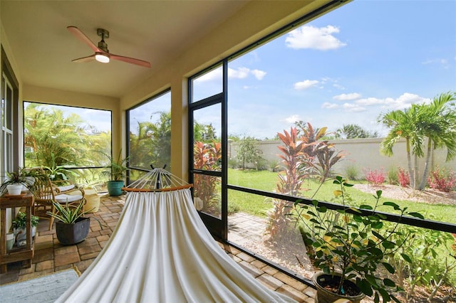 sunroom featuring ceiling fan