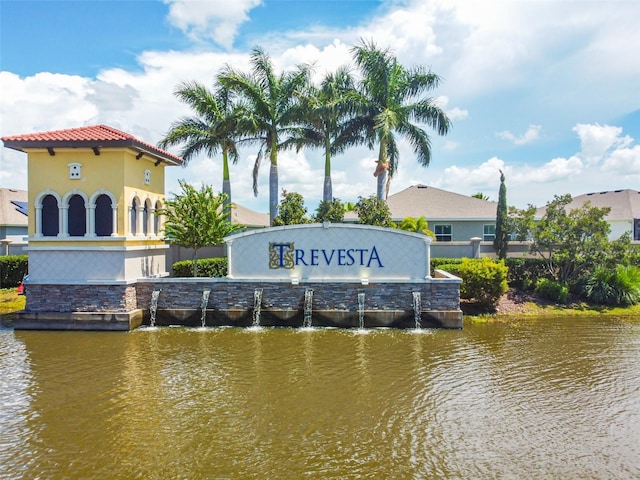 community sign with a water view