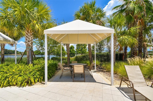 view of patio featuring a gazebo and a water view