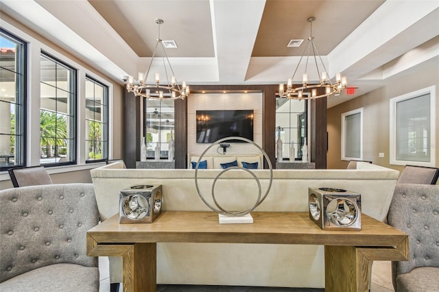 dining space with a raised ceiling and an inviting chandelier