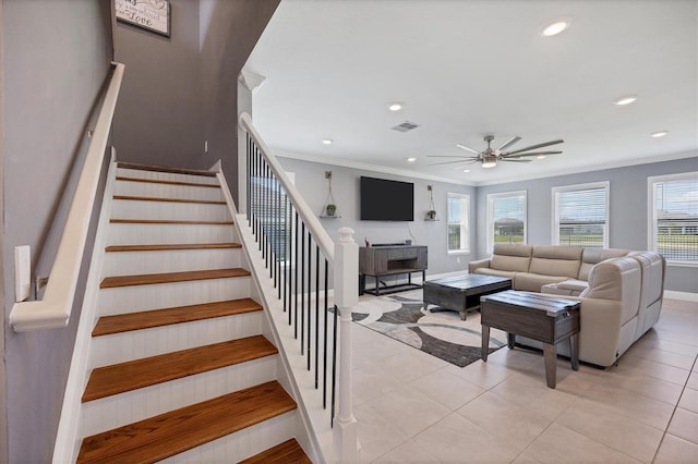 tiled living room featuring ornamental molding and ceiling fan