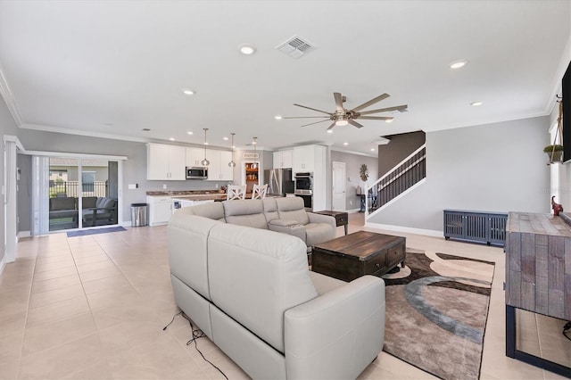 tiled living room featuring crown molding and ceiling fan