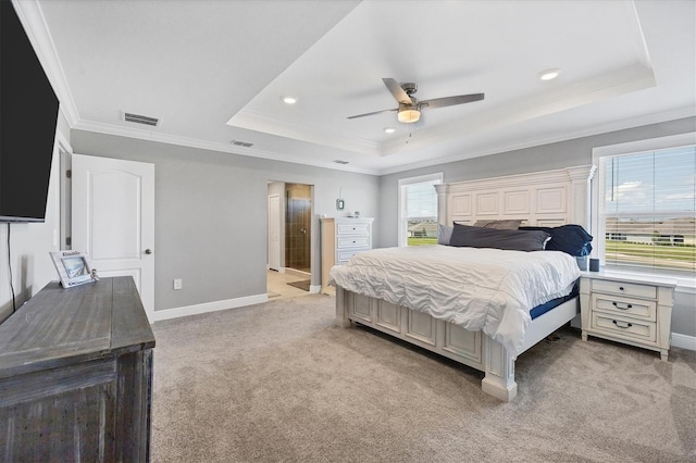 carpeted bedroom featuring ornamental molding, a tray ceiling, and ceiling fan