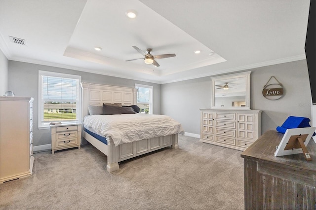 carpeted bedroom featuring ornamental molding, a raised ceiling, and ceiling fan