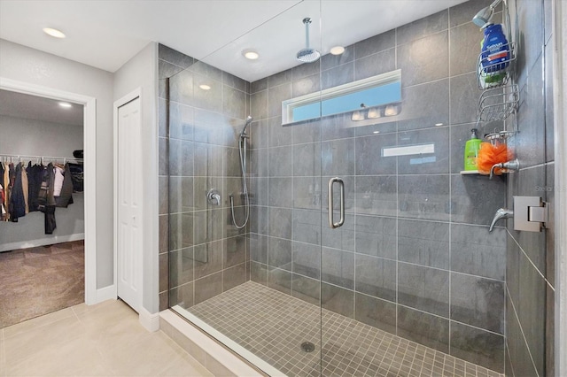 bathroom featuring a shower with shower door and tile patterned flooring