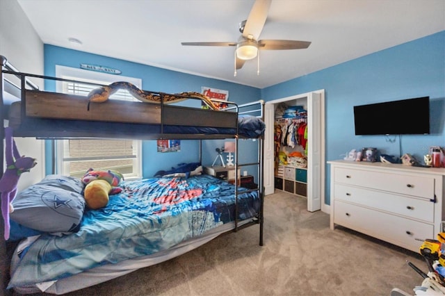 carpeted bedroom with a closet, multiple windows, and ceiling fan