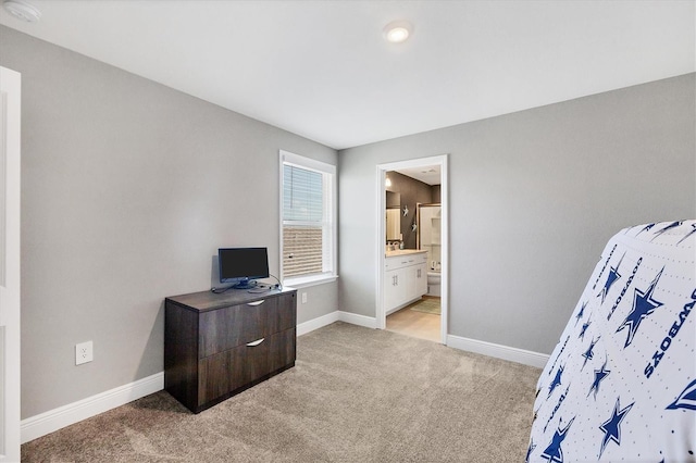 bedroom with light carpet and ensuite bath